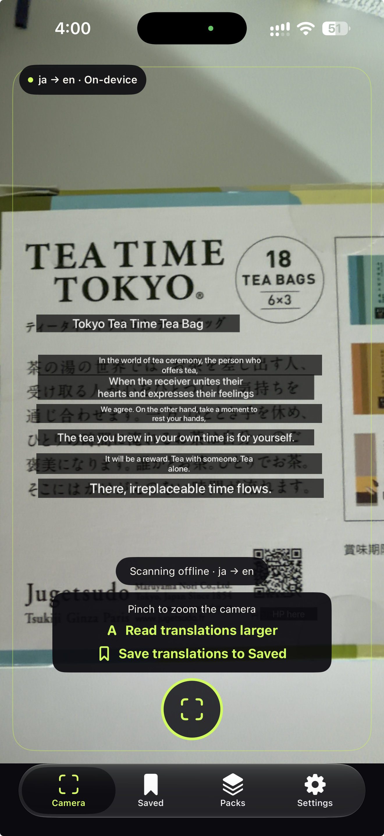 Ghost Translate iPhone camera translating Japanese text on a tea box into English